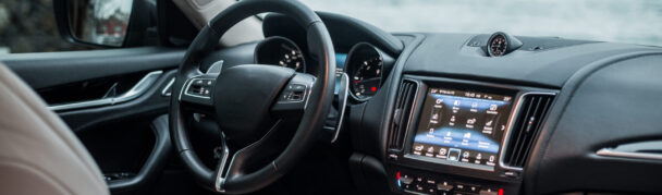 Navigation monitor, control wheel and front seat of a black car